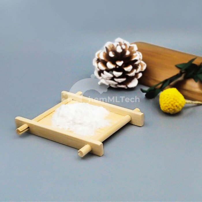 White Kojic Acid powder on bamboo tray, with pinecone and dried flowers, used in skin tone-evening and anti-spot skincare