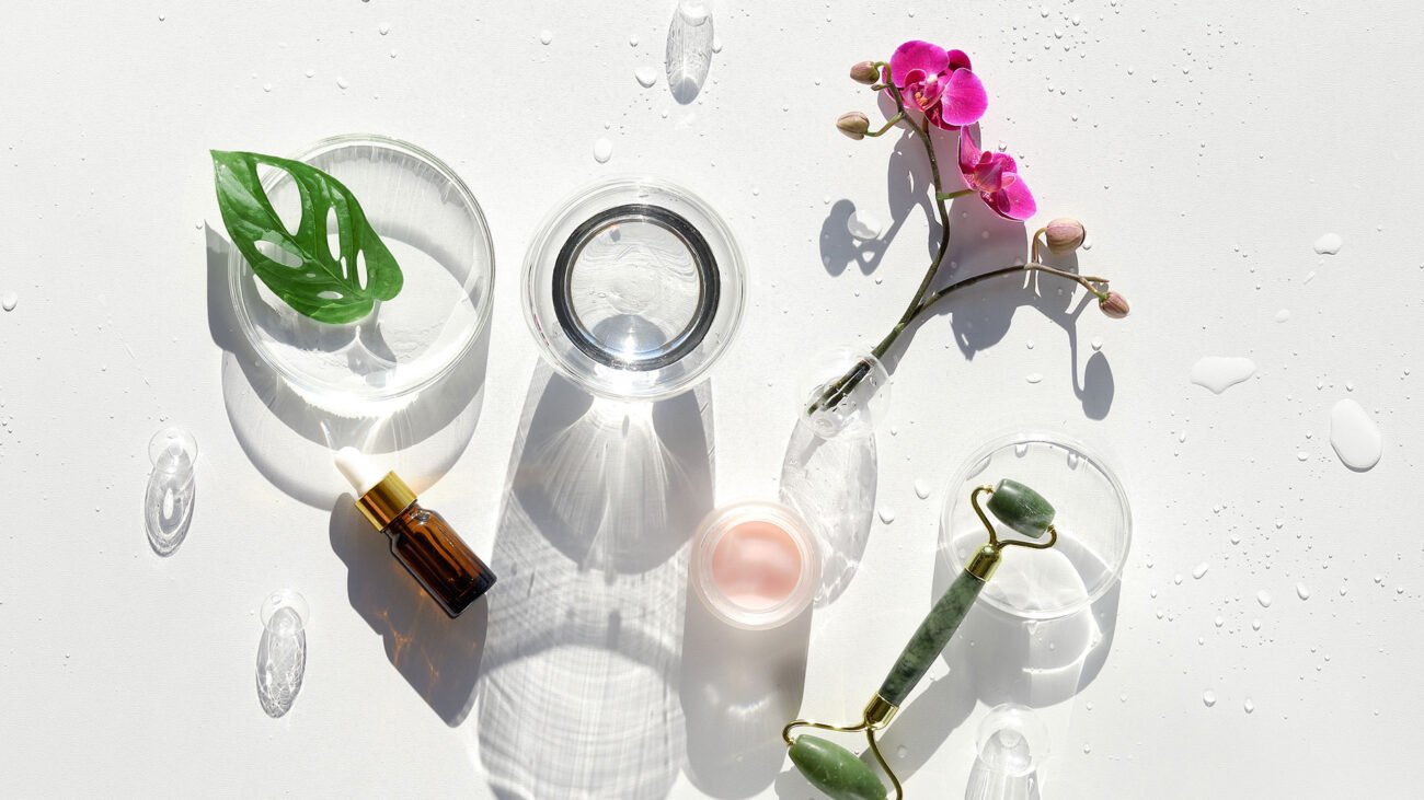 Skincare flat lay with natural elements, jade roller, and beauty products for glutathione skincare routine