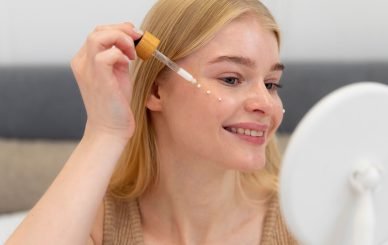 Young woman applying Snap 8 Peptide serum to her face for wrinkle reduction and smoother skin
