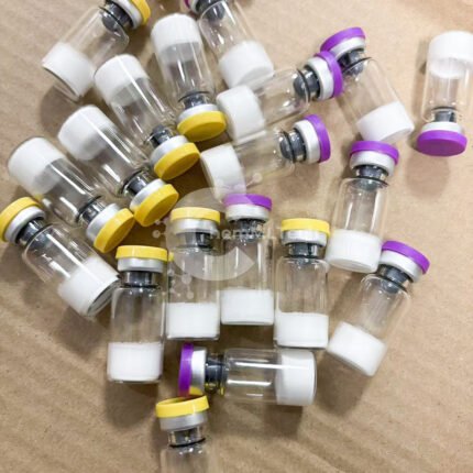 Multiple TB500 vials with yellow and purple caps containing freeze-dried peptide powder