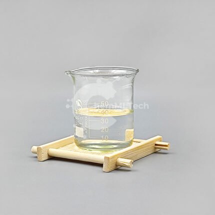Methacrylic Anhydride liquid in a 50ml glass beaker on wooden tray with clear appearance and purity