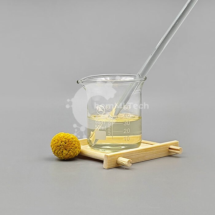 Clear yellow liquid Cyclohexylamine in a lab beaker with a glass stirring rod