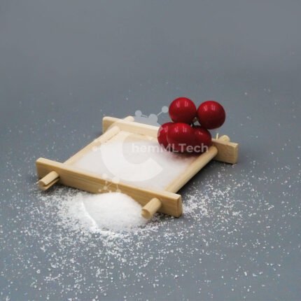 White crystalline powder of D-(-)-Tartaric Acid in a wooden tray with decorative red berries